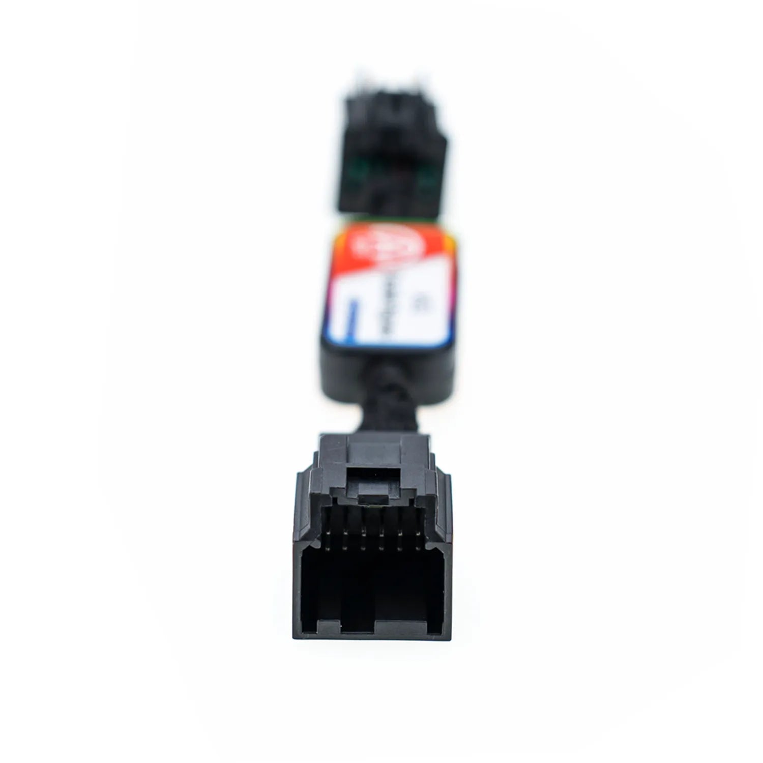 A black automotive bypass module labeled