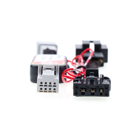 A close-up view of the "Idle Stop Disable Bypass" device shows two connectors, one white and one black, with red wires attached to them.