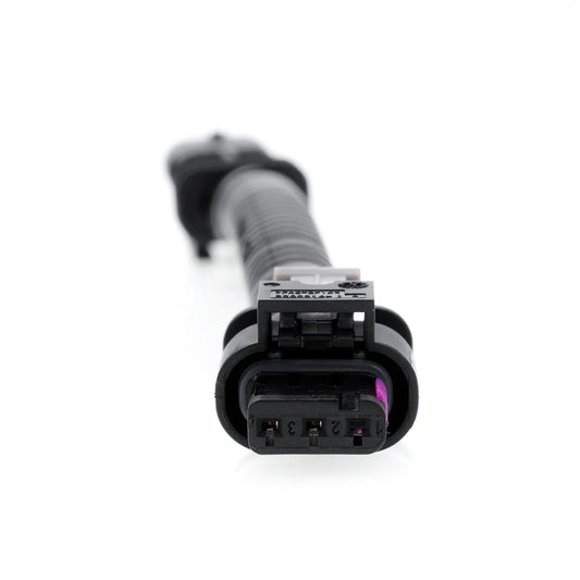 A black plastic wiring harness, featuring a circle shape, shows its interior with a three-pin female connector.