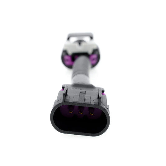 Automotive electrical connector with black housing and purple terminals, connected by a black corrugated tube for signal transmission. One connector is a 3-pin male connector.