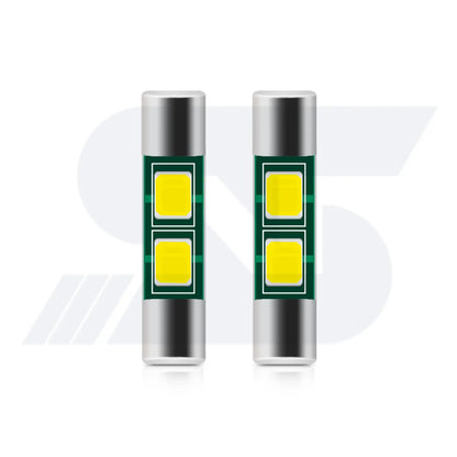 Two cylindrical LED car bulbs with silver ends and dual yellow light panels on a green circuit board, displayed side by side on a white background.