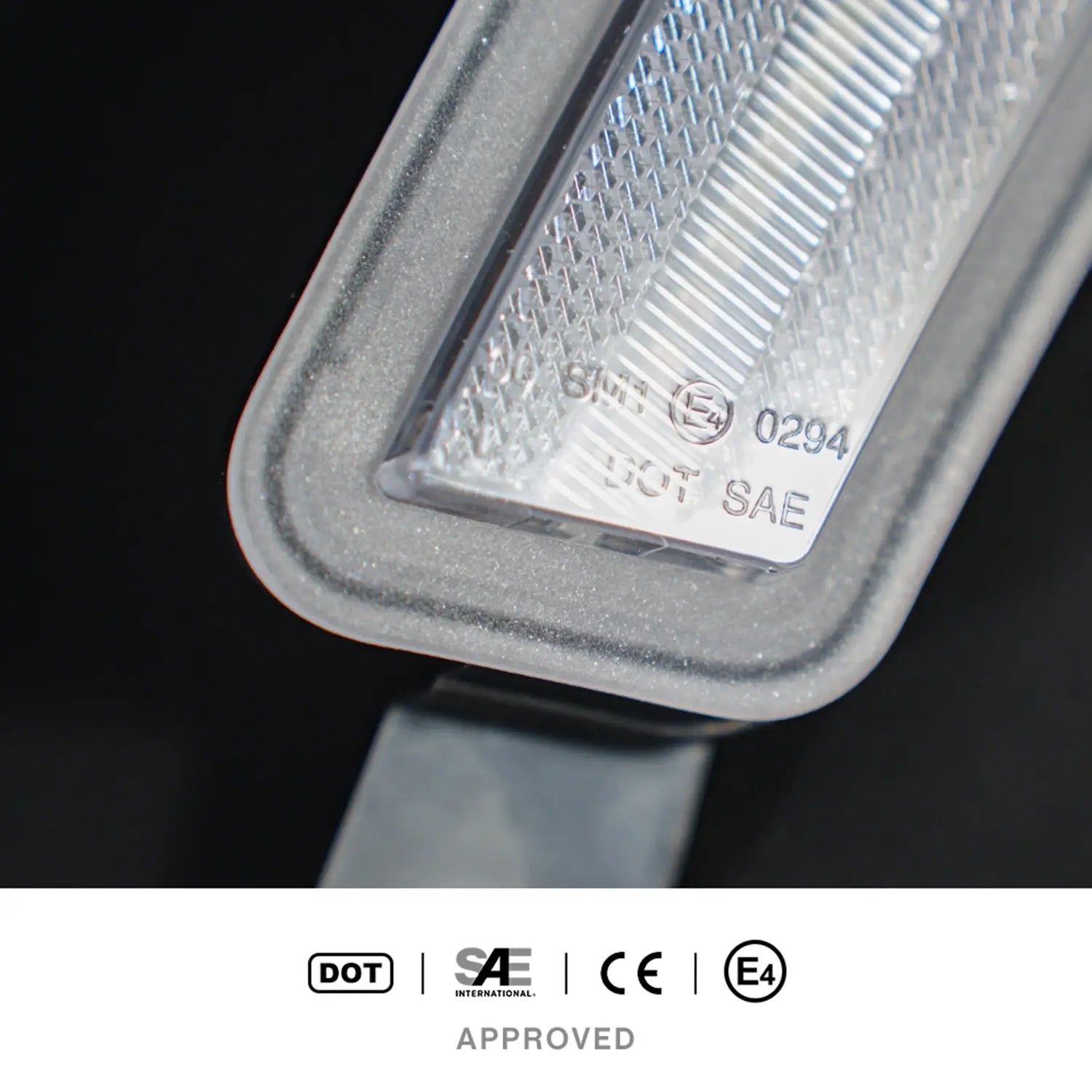 Close-up of LED turn signal light lens showing certification markings including DOT, SAE, CE, and E4. Image highlights legal compliance and international safety approvals.