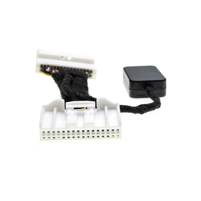 The image shows a close-up of an Idle Stop Disable Bypass device with two white multi-pin connectors and a black module attached via a short cable.