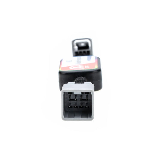A black ASS Disable Bypass device with "A OFF" and "First Choice" labels, featuring gray connectors on both ends, used for automotive applications. There is a gray 8-pin male connector on one end.