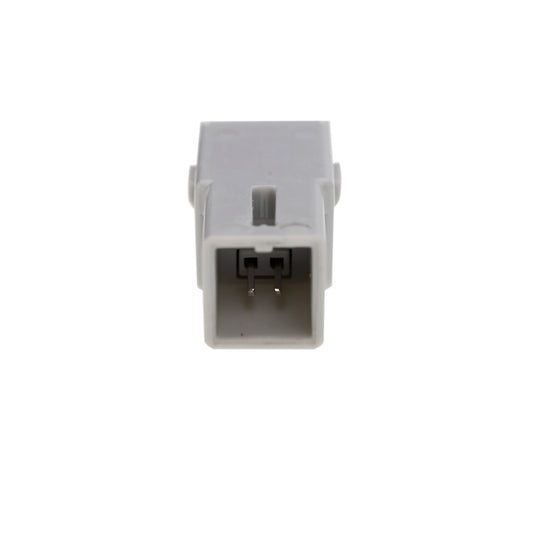 A gray plastic object, featuring a rectangular shape and a slot-like opening, shows its interior with a two-pin connector.